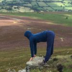 woman doing yoga on a mountain