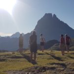 people doing yoga on a mountain in the pyrenees