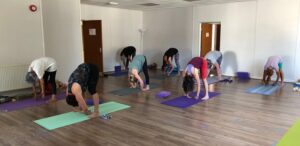 Yoga class doing forward bends