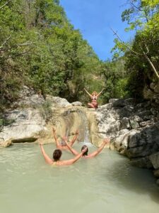 people doing yoga in a mountain pool