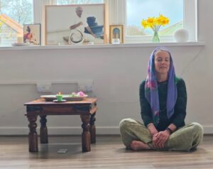 woman meditating with scarf on her head